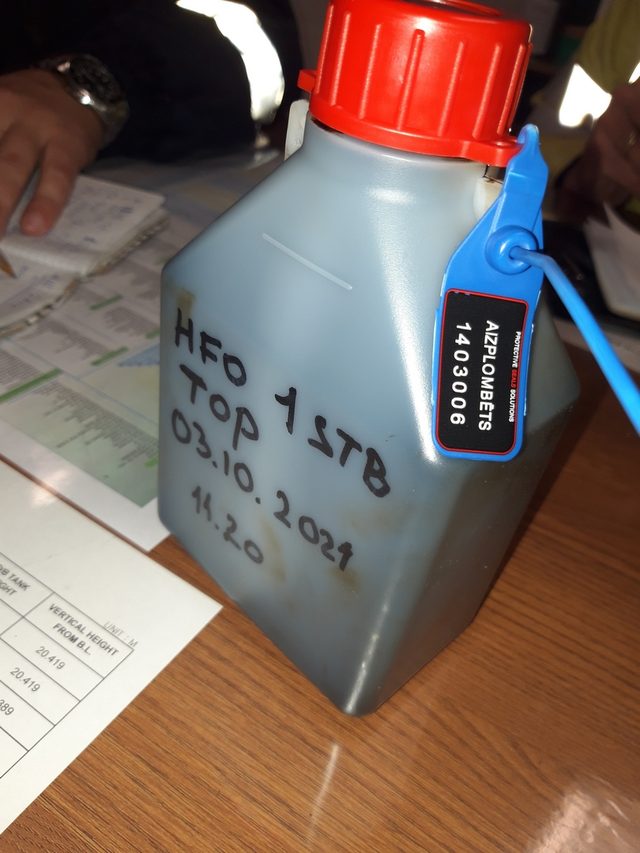 Fuel oil sample bottle labelled and closed with a numbered seal